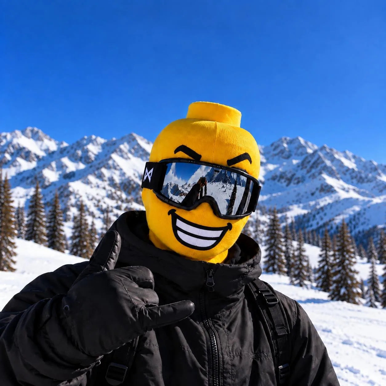 Yellow knit ski mask with a big grin, worn with mirrored ski goggles